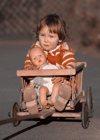 Child holding baby doll